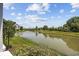Scenic view of a lush pond with a fountain surrounded by mature trees and landscaping at 141 Lazy Willow Ln. # 103, Myrtle Beach, SC 29577