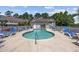 Inviting kidney shaped pool with plenty of seating, surrounded by lush landscaping and comfortable lounging options at 141 Lazy Willow Ln. # 103, Myrtle Beach, SC 29577