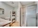 Bright bathroom with a glass-enclosed shower, and convenient shelving for storage at 1615 S Ocean Blvd. # 4, Surfside Beach, SC 29575