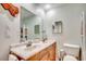 Bathroom featuring double sinks with granite vanity and a large mirror at 1615 S Ocean Blvd. # 4, Surfside Beach, SC 29575