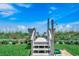 Private beach access with outdoor shower, lush landscaping, and benches overlooking the ocean at 1615 S Ocean Blvd. # 4, Surfside Beach, SC 29575