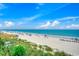 Expansive beach with white sands, clear ocean, blue sky, and beachgoers enjoying the sun at 1615 S Ocean Blvd. # 4, Surfside Beach, SC 29575