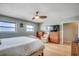 Well-lit bedroom with two windows, a ceiling fan, and classic wood furniture at 1615 S Ocean Blvd. # 4, Surfside Beach, SC 29575