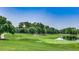Lush green golf course with mature trees, a tranquil pond, and well-manicured fairways at 1615 S Ocean Blvd. # 4, Surfside Beach, SC 29575