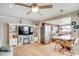 Open-concept living room with entertainment center, ceiling fan, and adjacent kitchen area at 1615 S Ocean Blvd. # 4, Surfside Beach, SC 29575
