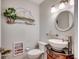 Charming powder room featuring decorative wall art and a stylish vessel sink on an ornate vanity at 1615 S Ocean Blvd. # 4, Surfside Beach, SC 29575