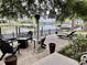 Serene backyard patio features comfortable seating, a modern heat lamp, and a water view at 17 Carson Creek Dr., Murrells Inlet, SC 29576