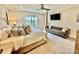 Bedroom features neutral colors, a four-poster bed, and a loveseat in the background at 17 Carson Creek Dr., Murrells Inlet, SC 29576