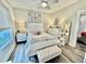 Bright bedroom featuring a large bed, neutral decor, and a comfortable bench at 17 Carson Creek Dr., Murrells Inlet, SC 29576
