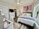 Bright bedroom featuring a large bed, a stylish desk and vanity area, and modern decor at 17 Carson Creek Dr., Murrells Inlet, SC 29576