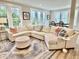 Bright living room with a large sectional sofa, ottoman, and an area rug at 17 Carson Creek Dr., Murrells Inlet, SC 29576