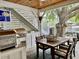 Covered outdoor kitchen area with a grill, a dining table and a beautiful view at 17 Carson Creek Dr., Murrells Inlet, SC 29576