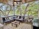 Relaxing screened porch with comfortable seating and scenic views of lush trees and water at 17 Carson Creek Dr., Murrells Inlet, SC 29576