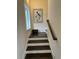 Staircase featuring elegant wood steps and a large pelican art piece at 17 Carson Creek Dr., Murrells Inlet, SC 29576