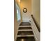 Stairway with dark wood steps, white risers, and wood handrail at 17 Carson Creek Dr., Murrells Inlet, SC 29576
