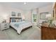 Comfortable bedroom with matching nightstands, blue accents, and light-filled window at 171 Waterloo Sunset Dr., Longs, SC 29568