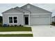 Charming single-story home showcasing a well-manicured lawn and a two-car garage, perfect for modern living at 171 Waterloo Sunset Dr., Longs, SC 29568