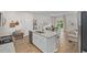 Stylish kitchen island featuring a stainless sink, seating, and an open floor plan at 171 Waterloo Sunset Dr., Longs, SC 29568