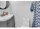 Well-lit bathroom showcasing new vanity, toilet, and patterned shower curtain at 1870 Auburn Dr. # 22A, Surfside Beach, SC 29575