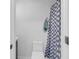 Well-lit bathroom showcasing new toilet and patterned shower curtain at 1870 Auburn Dr. # 22A, Surfside Beach, SC 29575