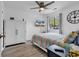 Cozy bedroom with white storage cabinet, wood floors, and a ceiling fan at 1870 Auburn Dr. # 22A, Surfside Beach, SC 29575
