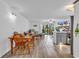 Open-concept living area with wood-look floors, slider to deck, and bar seating at 1870 Auburn Dr. # 22A, Surfside Beach, SC 29575