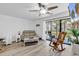 Bright living area with neutral tones, ceiling fan, and sliding glass doors to outdoor space at 1870 Auburn Dr. # 22A, Surfside Beach, SC 29575