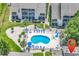 Aerial view of a kidney-shaped community pool with lounge chairs and manicured landscaping at 1870 Auburn Dr. # 22A, Surfside Beach, SC 29575