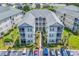 Aerial view of condominiums with multiple stories, balconies, convenient parking, and lush landscaping at 2020 Cross Gate Blvd. # 203, Surfside Beach, SC 29575