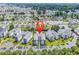 Community aerial view features landscaping, complex, parking, and nearby homes with ponds at 2020 Cross Gate Blvd. # 203, Surfside Beach, SC 29575