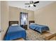 A cozy bedroom with two twin beds, wood headboards, and a ceiling fan at 2020 Cross Gate Blvd. # 203, Surfside Beach, SC 29575