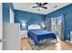 Bright blue bedroom with a queen bed and a sliding glass door leading to a balcony at 2020 Cross Gate Blvd. # 203, Surfside Beach, SC 29575