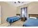 A cozy bedroom with two twin beds, wood headboards, and a ceiling fan at 2020 Cross Gate Blvd. # 203, Surfside Beach, SC 29575