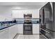 Well-lit kitchen featuring stainless steel appliances, white cabinets, and unique blue countertop at 2020 Cross Gate Blvd. # 203, Surfside Beach, SC 29575