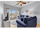 Bright living room featuring a ceiling fan, comfortable blue couches, and sliding doors to the balcony at 2020 Cross Gate Blvd. # 203, Surfside Beach, SC 29575