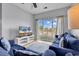 A cozy living room featuring comfortable blue couches, a TV, and a sliding door to a balcony at 2020 Cross Gate Blvd. # 203, Surfside Beach, SC 29575