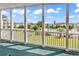Covered patio offering views of the community lawn and pool area on a bright sunny day at 2020 Cross Gate Blvd. # 203, Surfside Beach, SC 29575