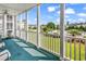 Relaxing patio with community views, featuring green carpeting and white columns at 2020 Cross Gate Blvd. # 203, Surfside Beach, SC 29575