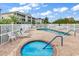 Inviting community pool and hot tub with lounge chairs and white picket fence at 2020 Cross Gate Blvd. # 203, Surfside Beach, SC 29575