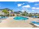 Community pool with lounge chairs, palm trees, and a building with balconies in background at 2020 Cross Gate Blvd. # 203, Surfside Beach, SC 29575