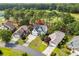 An aerial view of a home situated among trees with a golf course in the background at 2077 N Berwick Dr., Myrtle Beach, SC 29575