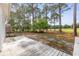 This property features a spacious wooden deck overlooking a lush, landscaped yard with mature trees at 2077 N Berwick Dr., Myrtle Beach, SC 29575