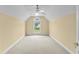 This is a bright bedroom featuring a vaulted ceiling and a large window overlooking the backyard at 2077 N Berwick Dr., Myrtle Beach, SC 29575