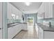 Galley kitchen with tile floors, white cabinets, granite countertops, and stainless steel appliances at 2077 N Berwick Dr., Myrtle Beach, SC 29575