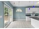 Kitchen with tile floors, white cabinets, granite countertops, and sliding glass door to the deck at 2077 N Berwick Dr., Myrtle Beach, SC 29575