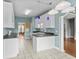 Eat-in kitchen features an island, tile floors, white cabinets, and stainless steel appliances at 2077 N Berwick Dr., Myrtle Beach, SC 29575