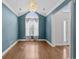 Spacious living room featuring hardwood floors, a chandelier, and abundant light at 2077 N Berwick Dr., Myrtle Beach, SC 29575