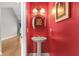 This powder room is striking with its red walls and decorative mirror and lighting at 2077 N Berwick Dr., Myrtle Beach, SC 29575