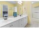 Bathroom with dual sinks, white cabinets, and a large mirror reflecting the bedroom at 213 South Myrtle Dr., Surfside Beach, SC 29575