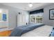 Serene bedroom with a large window, hardwood floors, and a glimpse into the attached bathroom at 213 South Myrtle Dr., Surfside Beach, SC 29575